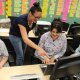 teacher pointing at a computer