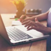 A nurse applies for scholarships on their laptop.